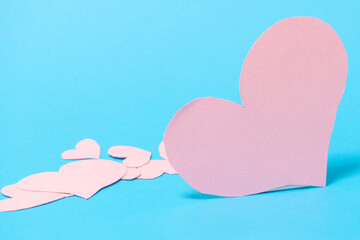 A big pink heart with smaller hearts on a blue background. Valentine's Day concept