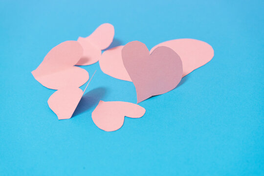group of pink hearts on a blue background. Valentine's Day concept
