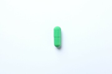 Green capsule on a white background