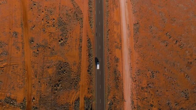 Moving through a Mars-like landscape in the Australian Outback, passing abandoned opal mines amidst the barren, red earth