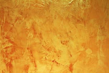 Empty golden textured background with copy space. Artistic and luxury background. Decorative yellow painted wall 