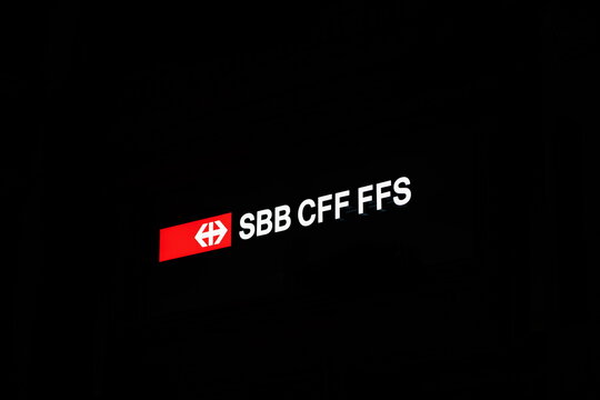 18-11-2024, Zurich, Switzerland. Swiss railways SBB CFF FFS illuminated sign or emblem at night. Zurich main railways station, looking up shot, no people, dark black background
