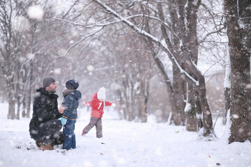Kids walk in the park first snow