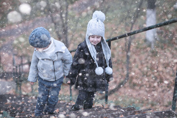 Kids walk in the park first snow