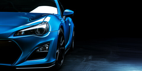 blue modern sports car on a dark background with copy space, banner