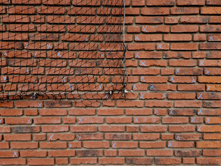Obraz premium repair of the facade, cladding of bricks and tiles. due to the weather and time, damaged and frost loosened tiles need to be replaced. crosses marked with chalk. under protection of a net pedestrian