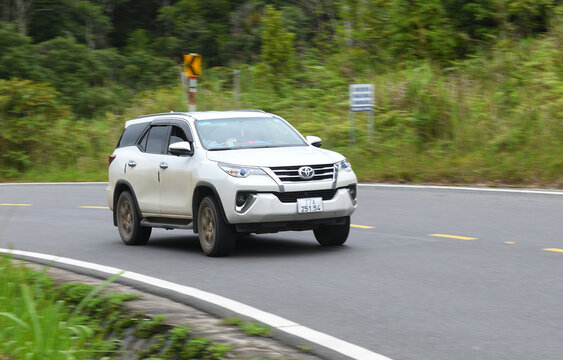 TOYOTA HILUX FORTUNER car of the year is driving on a mountain road.