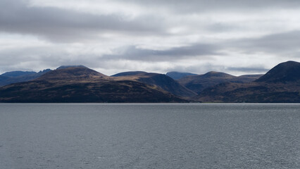 Scenic panoramic view of ocean and mountainous landscape of Isle of Arran in Clyde of Firth, Inner...