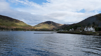 Scenic coastal and ocean view of Lochranza town with mountainous terrain on Isle of Arran, Inner Hebrides of Western Scotland UK