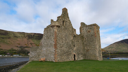 Scenic view of Lochranza Castle overlooking ocean on remote Isle of Arran in Inner Hebrides, Scotland UK