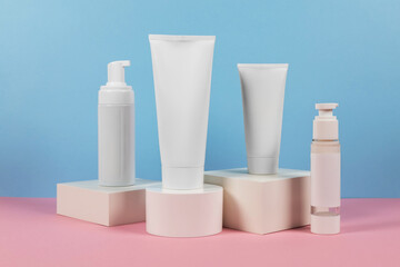 White plastic tubes without label displayed on podium. Scene for advertising cosmetics base