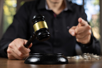 Judge banging judge's gavel index finger pointing. Law Lord wearing gown using a hammer for...