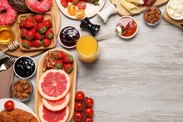 Different tasty food served for brunch on wooden table, flat lay. Space for text