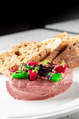 chicken liver pate with sliced bread on table