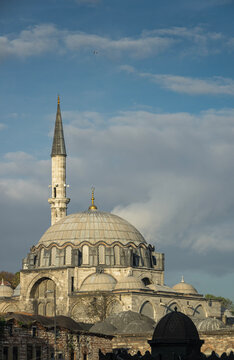 Historic mosque with a tall minaret under cloudy skies