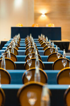 Rows of conference room chairs with bottles and glasses
