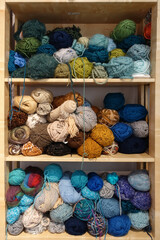 Various colors wool balls and yarns on the shelf