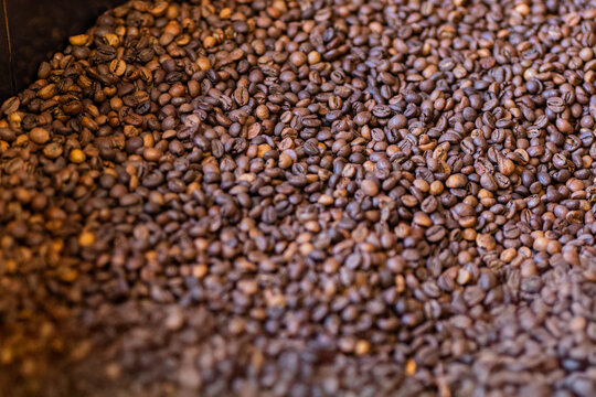 Rich aroma of freshly roasted coffee beans in a textured pile