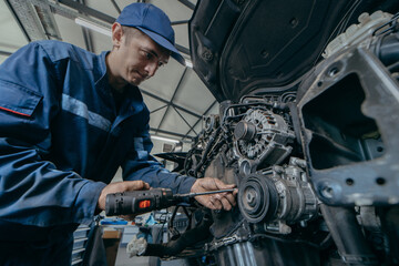 Auto mechanic repairs an engine. Replacing the timing chain