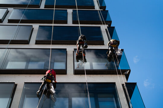 Workers Installing Pigeon Spikes on Skyscraper
