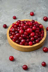 Cranberries in a wooden bowl on a dark background.  top view, free space. Vitamins, benefits.