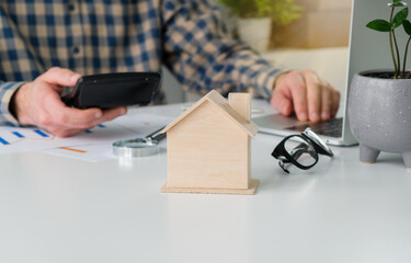 Close-up of a judge's hammer small wooden toy house On the table in the courtroom concept of real...