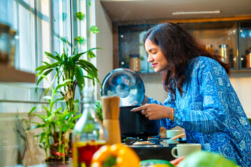 Couple standing by the stove, savoring the delicious aroma of steaming soup in a pot