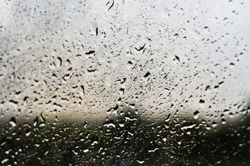 Raindrops on the window glass, shallow dof - abstract macro background.
