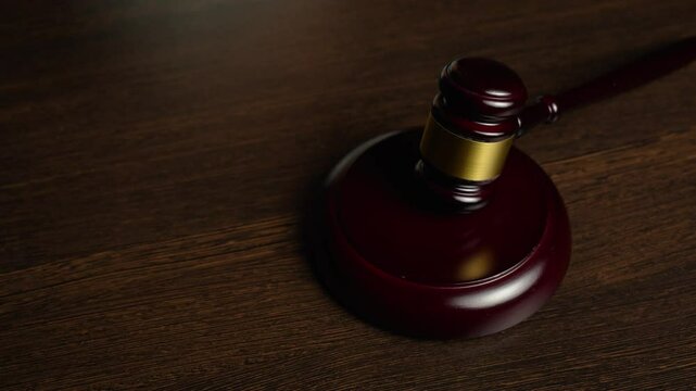 Justice and money, corruption and bribery concept. Close-up hand giving bribe money to Lawyer with Judge gavel on table