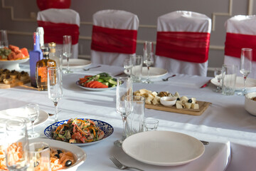 Cold snacks on the festive table. Food and drinks at the banquet.