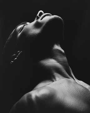 A striking black and white photograph capturing a man gazing upwards
