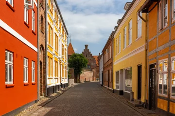 Fototapete Rund a beautiful city scape view through the small streets in the town Ribe in Denmark. With small and historic half-timbered houses in tiny alleys. © A.N.Foto