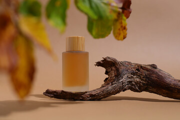 Glass cosmetic bottle with wooden trunk, container mockup