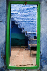 The entrance of a blue painted house inside the old city of Jodhpur in Rajasthan, India.