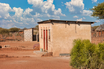 traditional African shack in a village, hut poverty accommodation house with outdoors toilet in the...