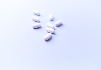 Amino acids tablets. Nutrition for bodybuilding. Fitness supplements on bright background. Soft focus. Copy space