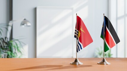 FLAGS OF KIRIBATI AND SOUTH SUDAN ON TABLE
