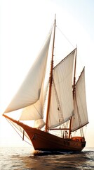 Obraz premium A majestic sailing ship with white sails navigating the calm sea.