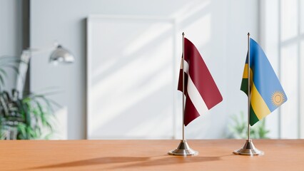 FLAGS OF LATVIA AND RWANDA ON TABLE