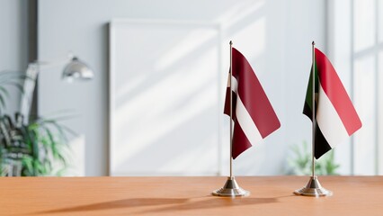 FLAGS OF LATVIA AND SUDAN ON TABLE