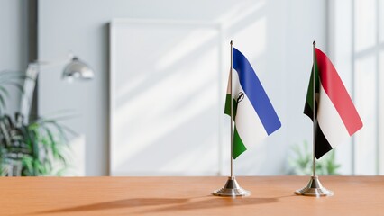 FLAGS OF LESOTHO AND SUDAN ON TABLE