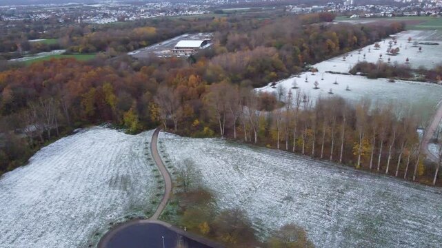 Aerial view of the late autumn forest and snow field in the rural area outside Eschborn, Hesse, Germany.