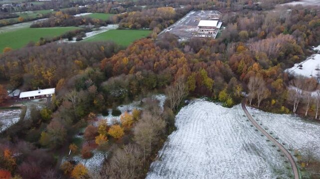 Aerial view of the late autumn forest and snow field in the rural area outside Eschborn, Hesse, Germany.