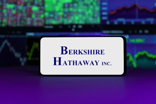 Berkshire Hathaway logo on mobile phone screen company shares rise or fall on stock exchange market 
