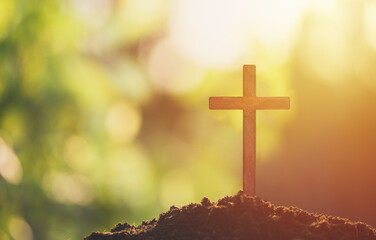 Christian wooden cross on a soil, Holy concept