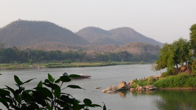 Sunset view of boats and ferries on the Mekong River in Luang Prabang, Laos