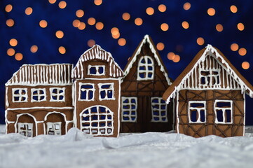 little home made gingerbread town with bokeh sky out of blue velvet and christmaslights as advent decoration for the family
