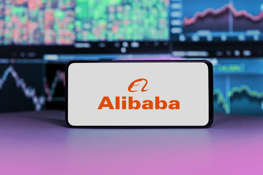 Alibaba logo on mobile phone screen. company shares rise or fall on stock exchange market 