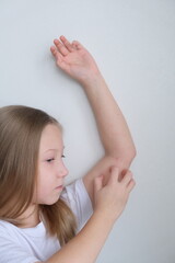 The child scratches atopic skin. Dermatitis, diathesis, allergy on the child's body.	