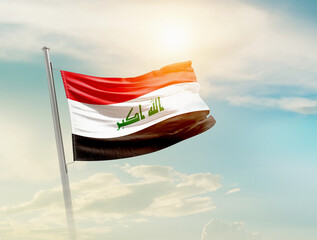 Iraq national flag waving in beautiful sky with mast. A proud moment flag waving with sunlight.